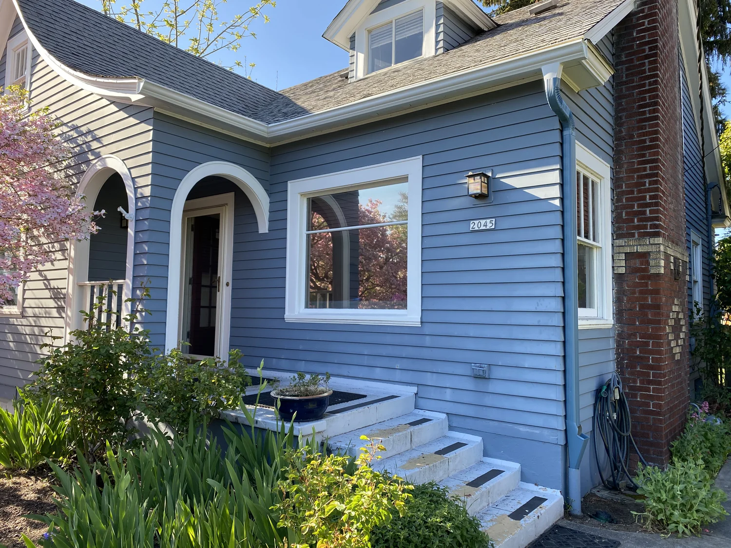 Bronze gutters on a detached garage with rainy driveway and downspout, Fisher's Landing WA area